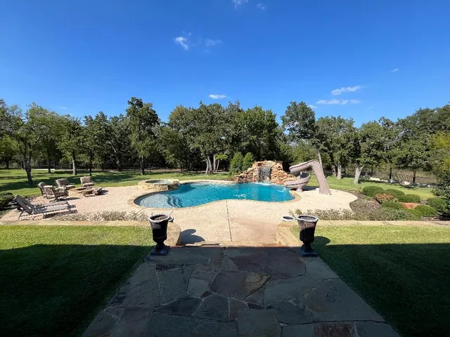 a view of a swimming pool with a yard