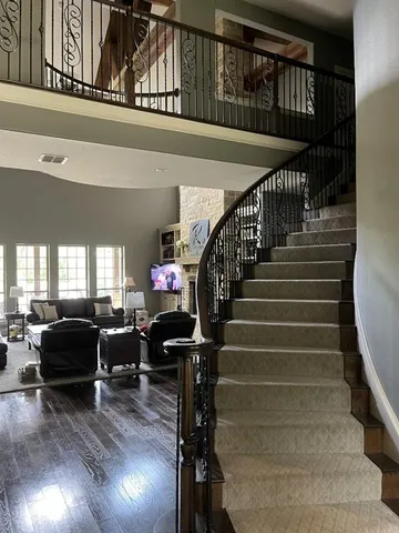 a view of entryway and hall with wooden floor