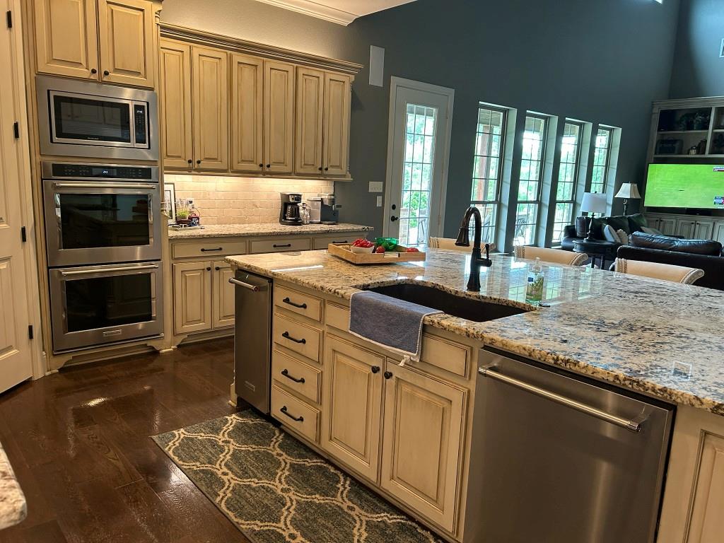 470 Granite Way Jacksboro, TX 76458 - Photo 10 of 22 a kitchen with stainless steel appliances granite countertop a stove a sink and a microwave