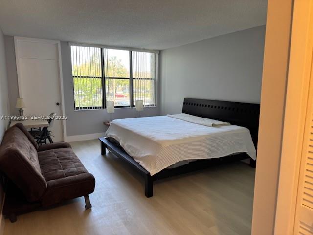 16300 Golf Club Road, Unit 208 Weston, FL 33326 - Photo 17 of 25 a bedroom with a bed couch and two windows