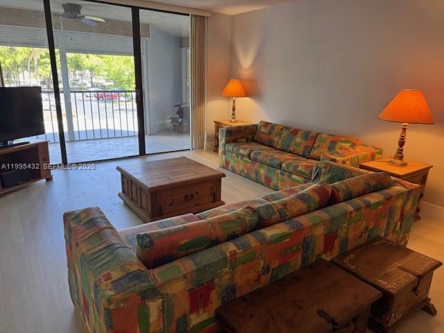 16300 Golf Club Road, Unit 208 Weston, FL 33326 - Photo 5 of 25 a living room with furniture and a lamp