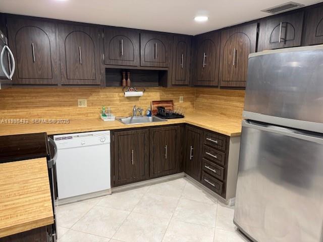 16300 Golf Club Road, Unit 208 Weston, FL 33326 - Photo 8 of 25 a kitchen with a sink and wooden cabinets