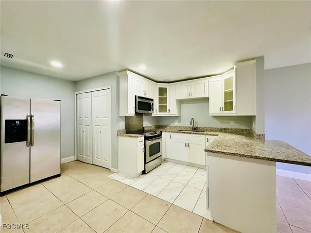 a kitchen with a sink cabinets and stainless steel appliances