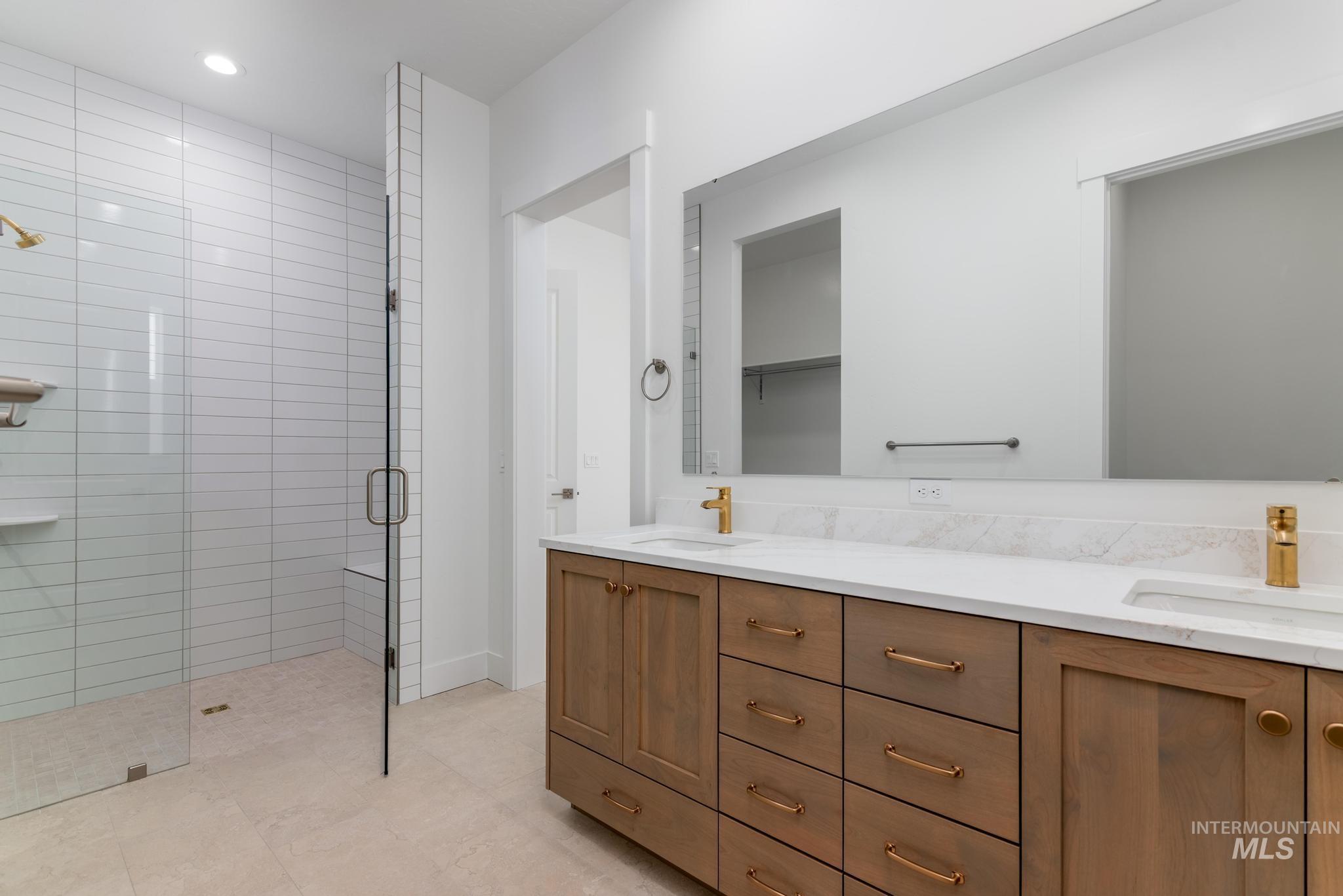 8531 West Chamblee Street Star, ID 83669 - Photo 17 of 37 Full bathroom featuring double vanity, a stall shower, and recessed lighting
