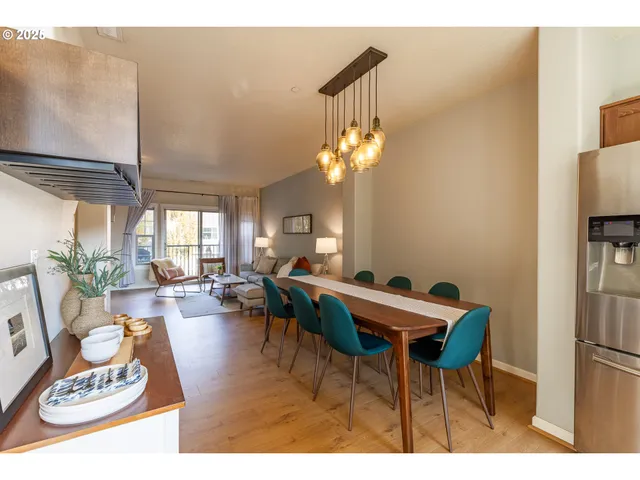 a living room with furniture a chandelier and a table