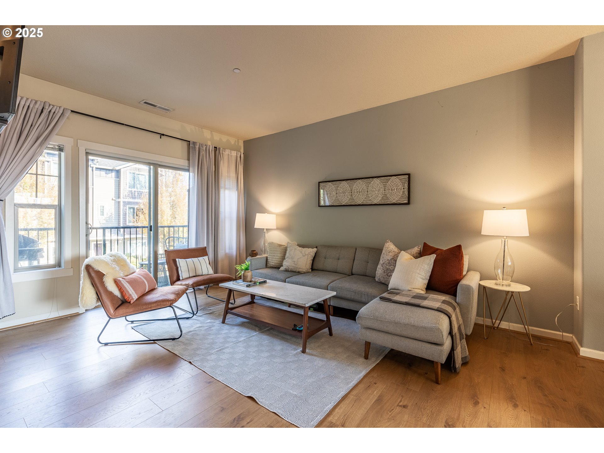 7974 Northeast Heiser Street Hillsboro, OR 97006 - Photo 14 of 32 a living room with furniture a large window and a flat screen tv