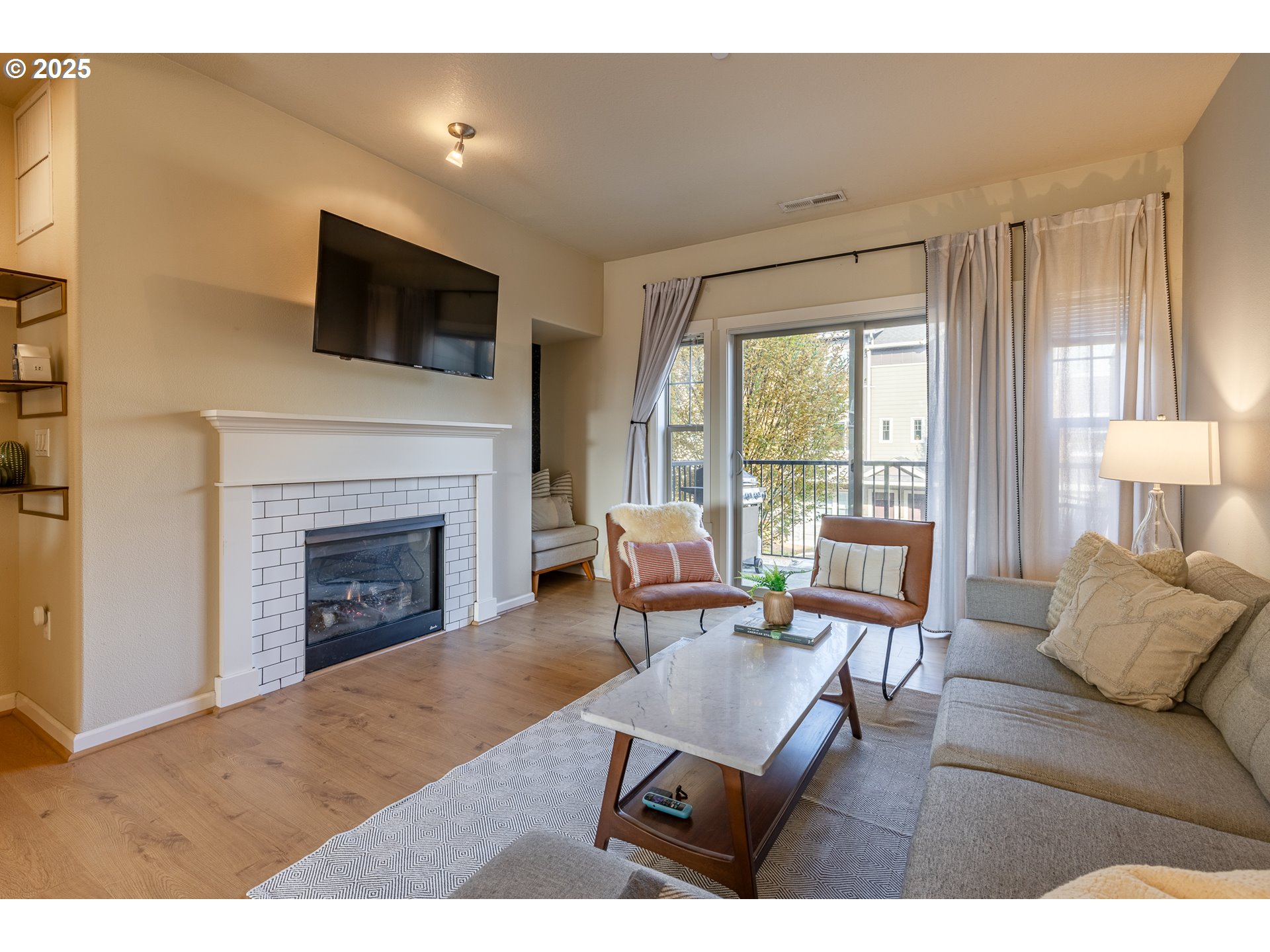 7974 Northeast Heiser Street Hillsboro, OR 97006 - Photo 16 of 32 a living room with furniture a flat screen tv and a fireplace