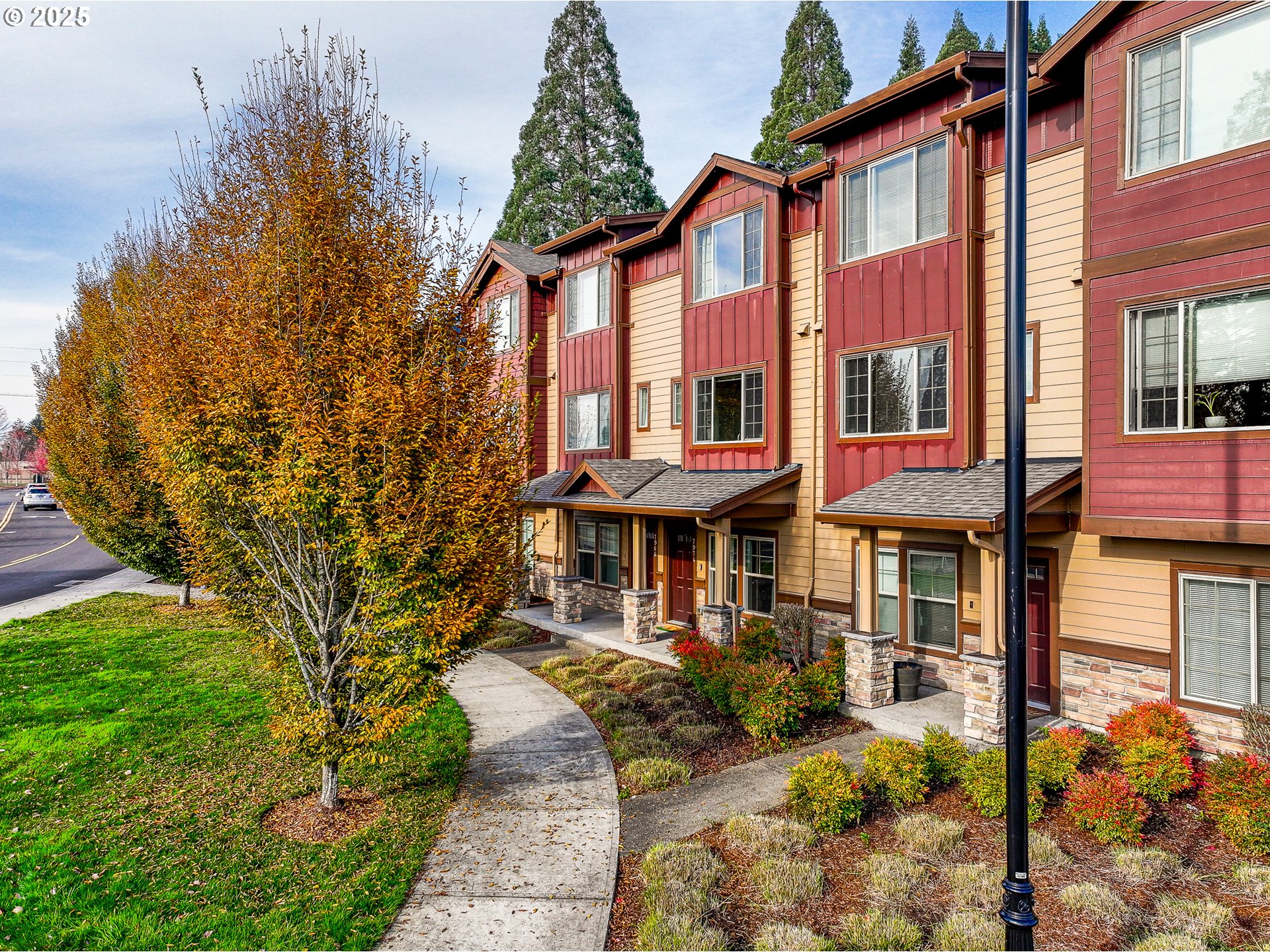 7974 Northeast Heiser Street Hillsboro, OR 97006 - Photo 2 of 32 a front view of a residential apartment building with a yard
