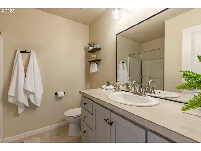 a bathroom with a sink a toilet and mirror