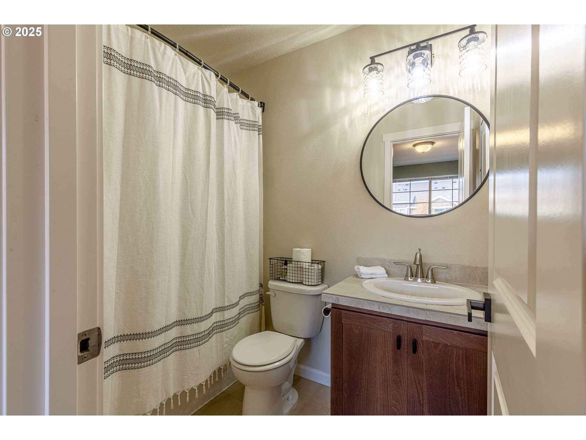 7974 Northeast Heiser Street Hillsboro, OR 97006 - Photo 24 of 32 a bathroom with a toilet a sink and a mirror