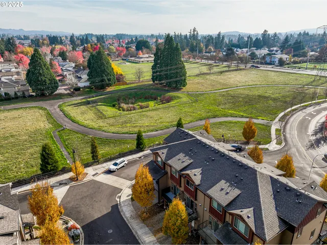 a view of a swimming pool with a patio and a garden