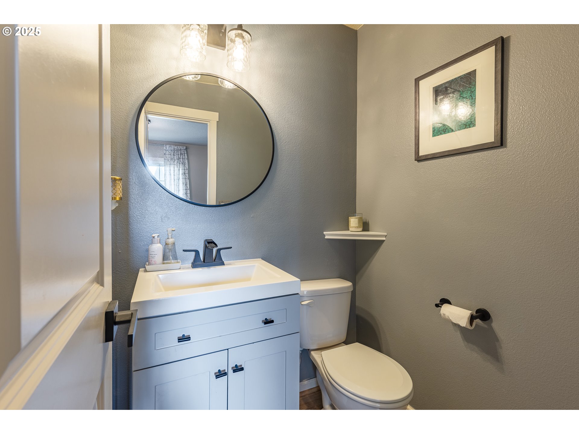 7974 Northeast Heiser Street Hillsboro, OR 97006 - Photo 5 of 32 a bathroom with a toilet a sink and mirror