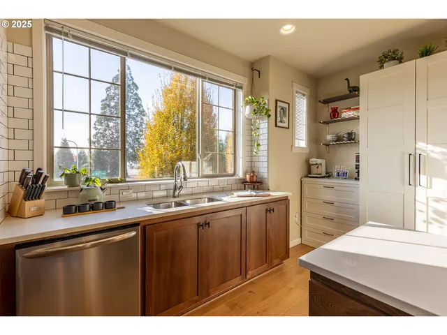 a kitchen with a sink a refrigerator and window