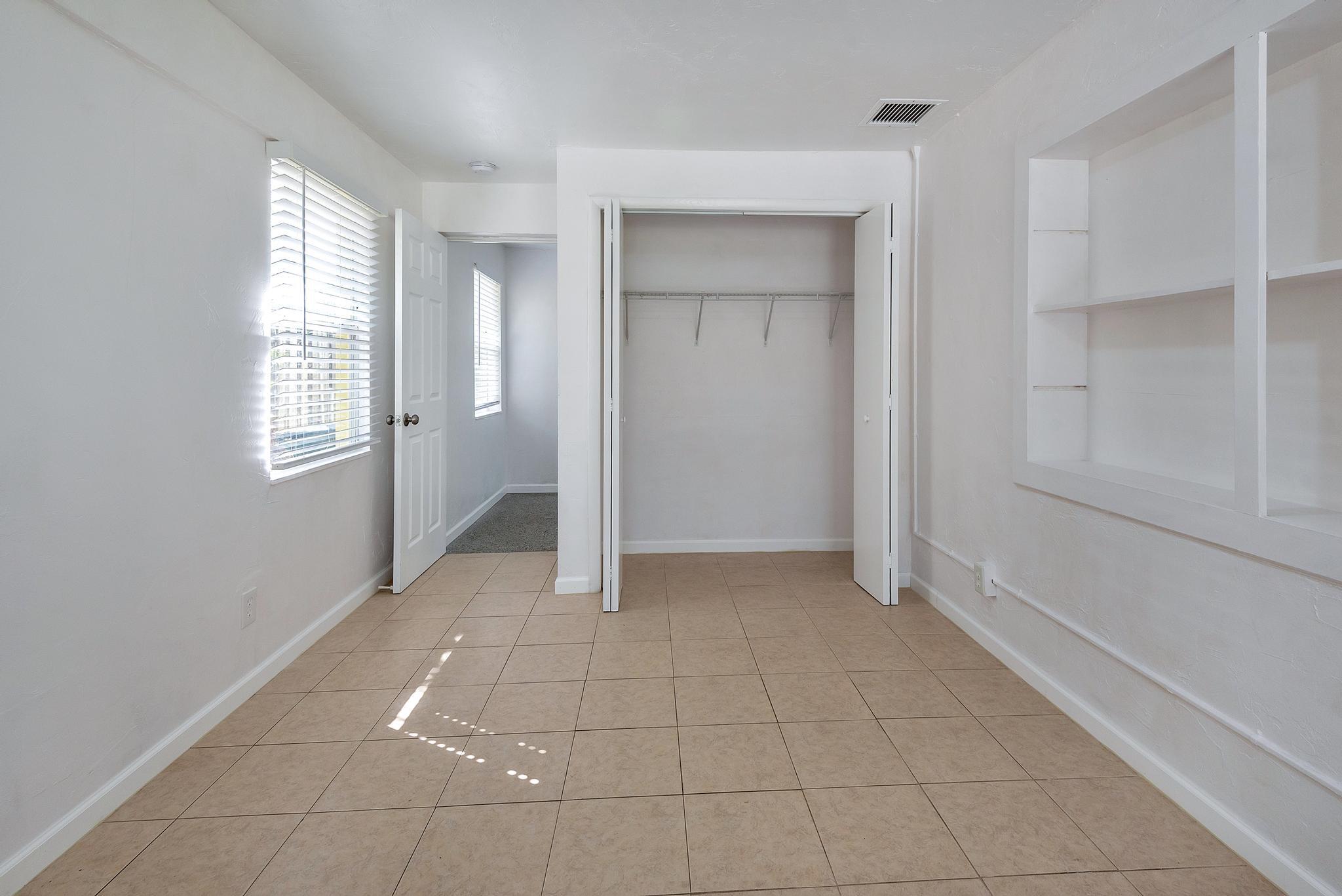 4882 Jefferson Road Delray Beach, FL 33445 - Photo 17 of 41 a view of an empty room with window and closet area