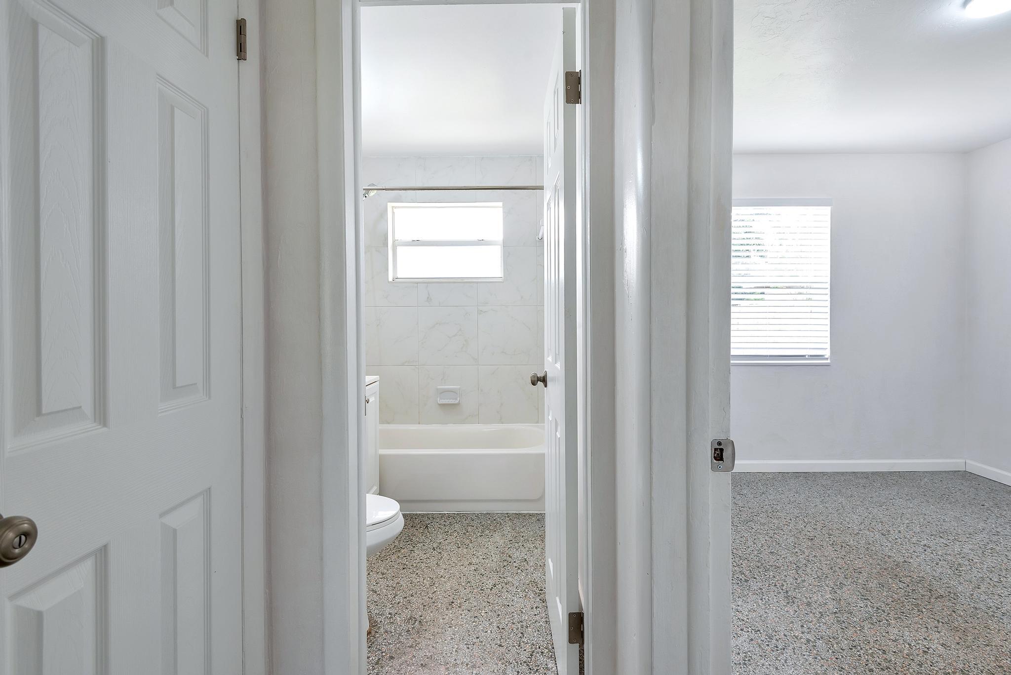 4882 Jefferson Road Delray Beach, FL 33445 - Photo 25 of 41 a bathroom with a bathtub and a shower