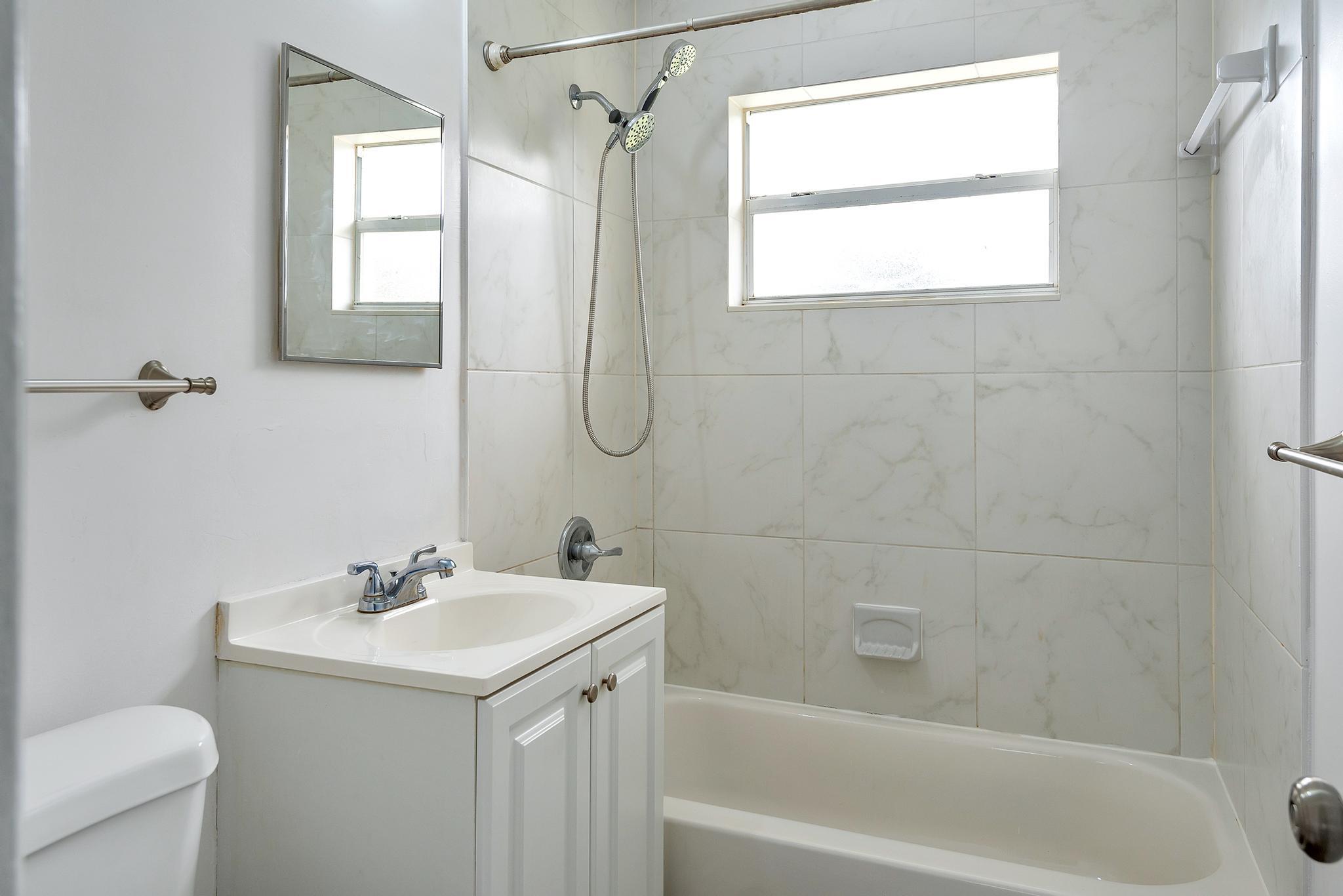4882 Jefferson Road Delray Beach, FL 33445 - Photo 26 of 41 a bathroom with a sink toilet and shower