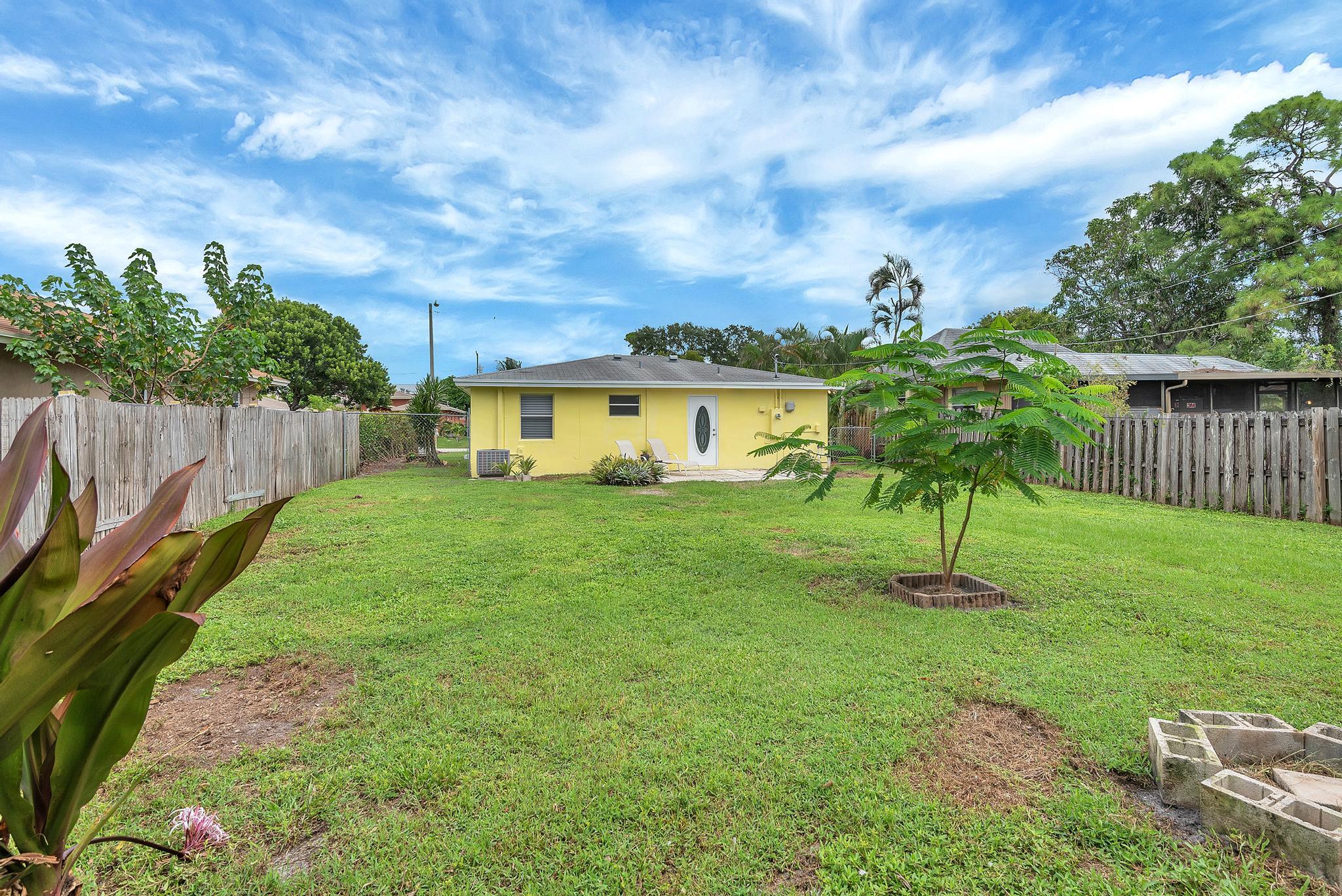 4882 Jefferson Road Delray Beach, FL 33445 - Photo 37 of 41 a house view with garden space