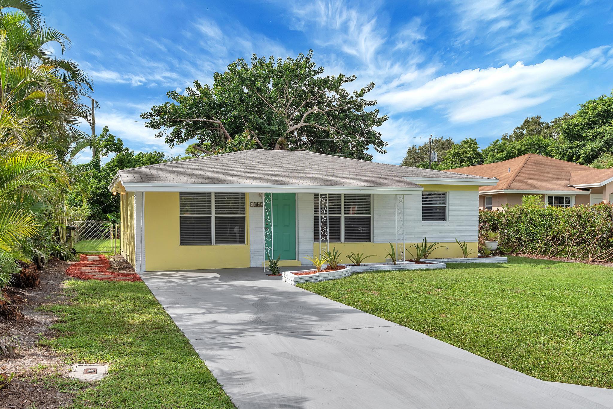 4882 Jefferson Road Delray Beach, FL 33445 - Photo 40 of 41 a front view of a house with a yard and porch