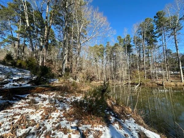 a view of a yard with wooden fence