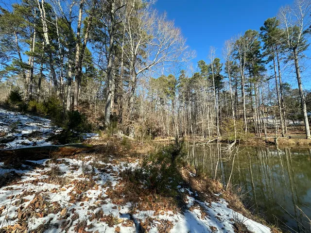 a view of a yard with wooden fence