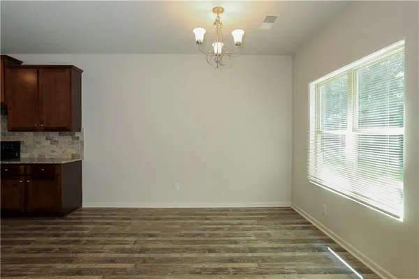 a view of a kitchen with a dishwasher cabinets and a large window