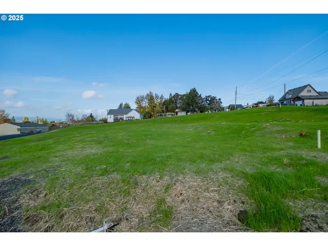 a view of a big yard with a house