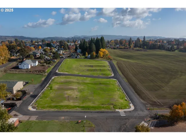 an aerial view of a tennis ground and a yard
