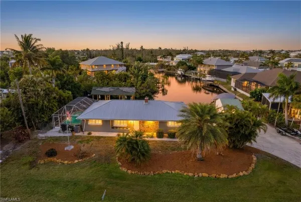 an aerial view of residential houses with outdoor space and swimming pool