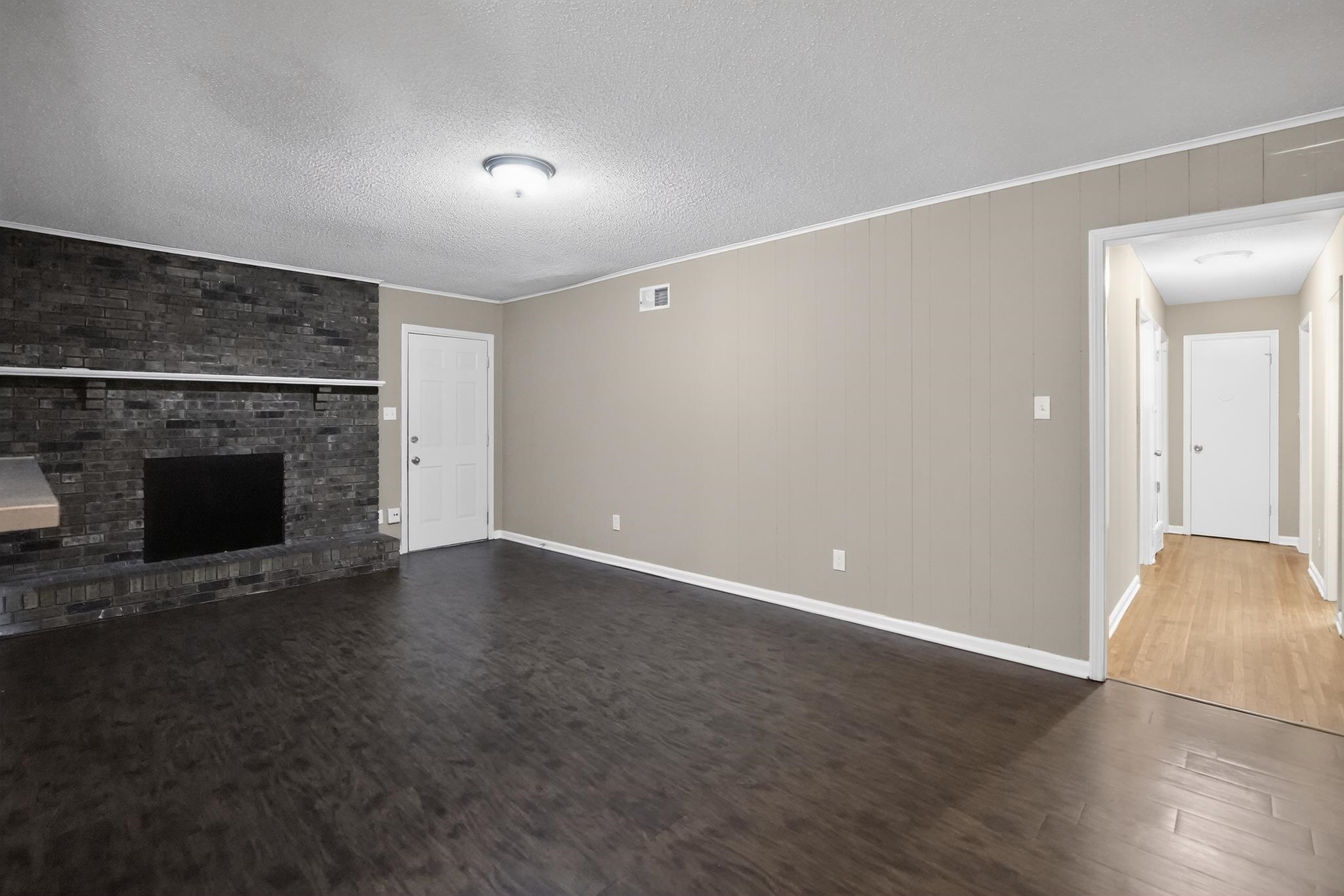 2015 East Holmes Road Memphis, TN 38116 - Photo 18 of 34 a view of empty room with wooden floor and fireplace