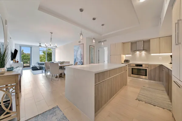 a large kitchen with stainless steel appliances lots of counter space and windows