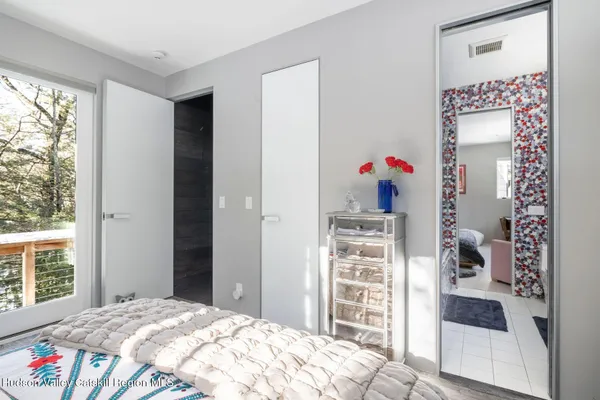 a bed room with a bed and a chair