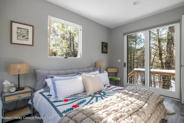 a bedroom with bed and a window