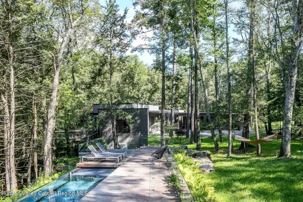 a view of a house with backyard and sitting area