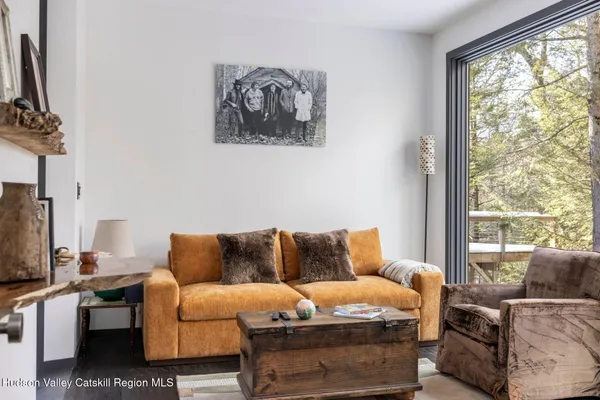 a living room with furniture and a floor to ceiling window