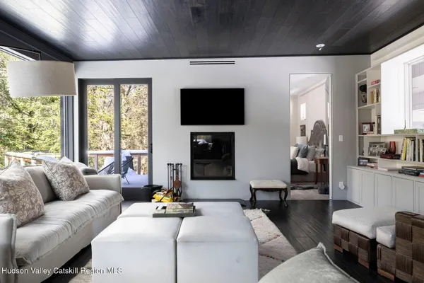 a living room with furniture and large windows