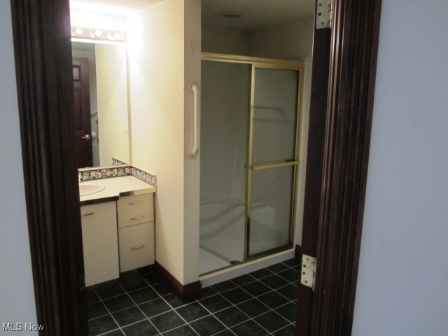 6999 Gates Road Gates Mills, OH 44040 - Photo 4 of 20 Bathroom with vanity, a stall shower, and dark tile patterned floors