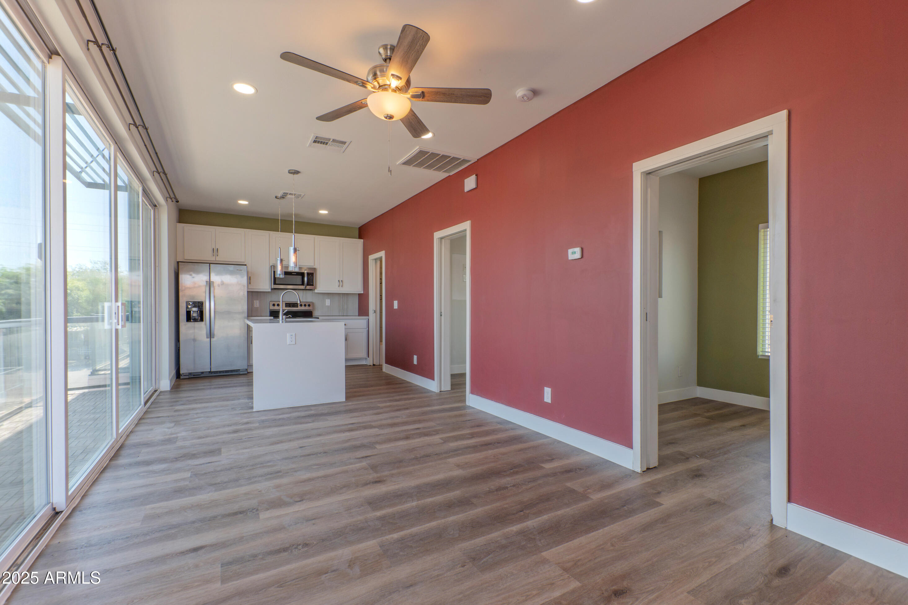 1106 South Montezuma Avenue Phoenix, AZ 85003 - Photo 13 of 15 a view of a kitchen with a refrigerator a ceiling fan and wooden floor