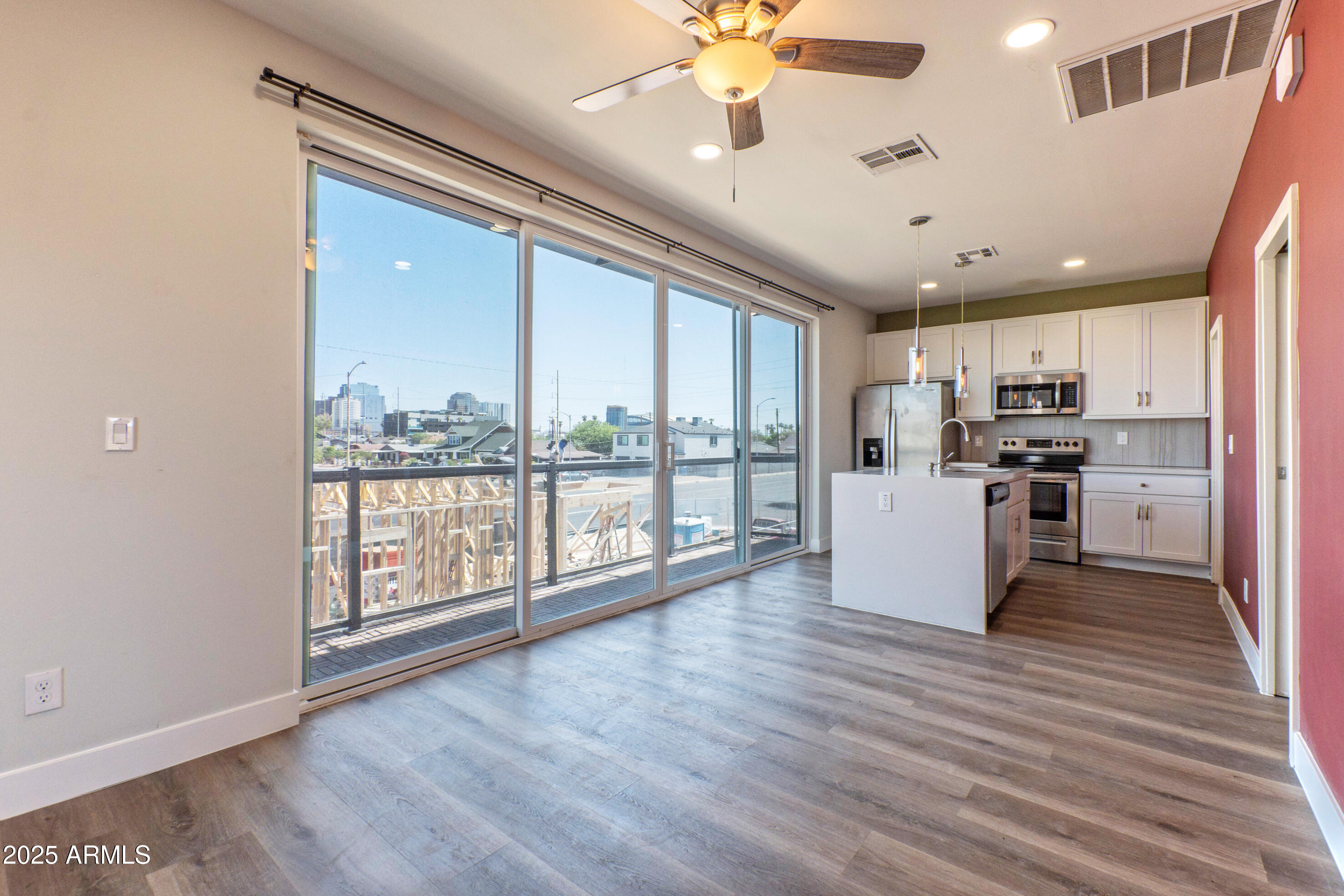 1106 South Montezuma Avenue Phoenix, AZ 85003 - Photo 14 of 15 a view of a kitchen with microwave and wooden floor
