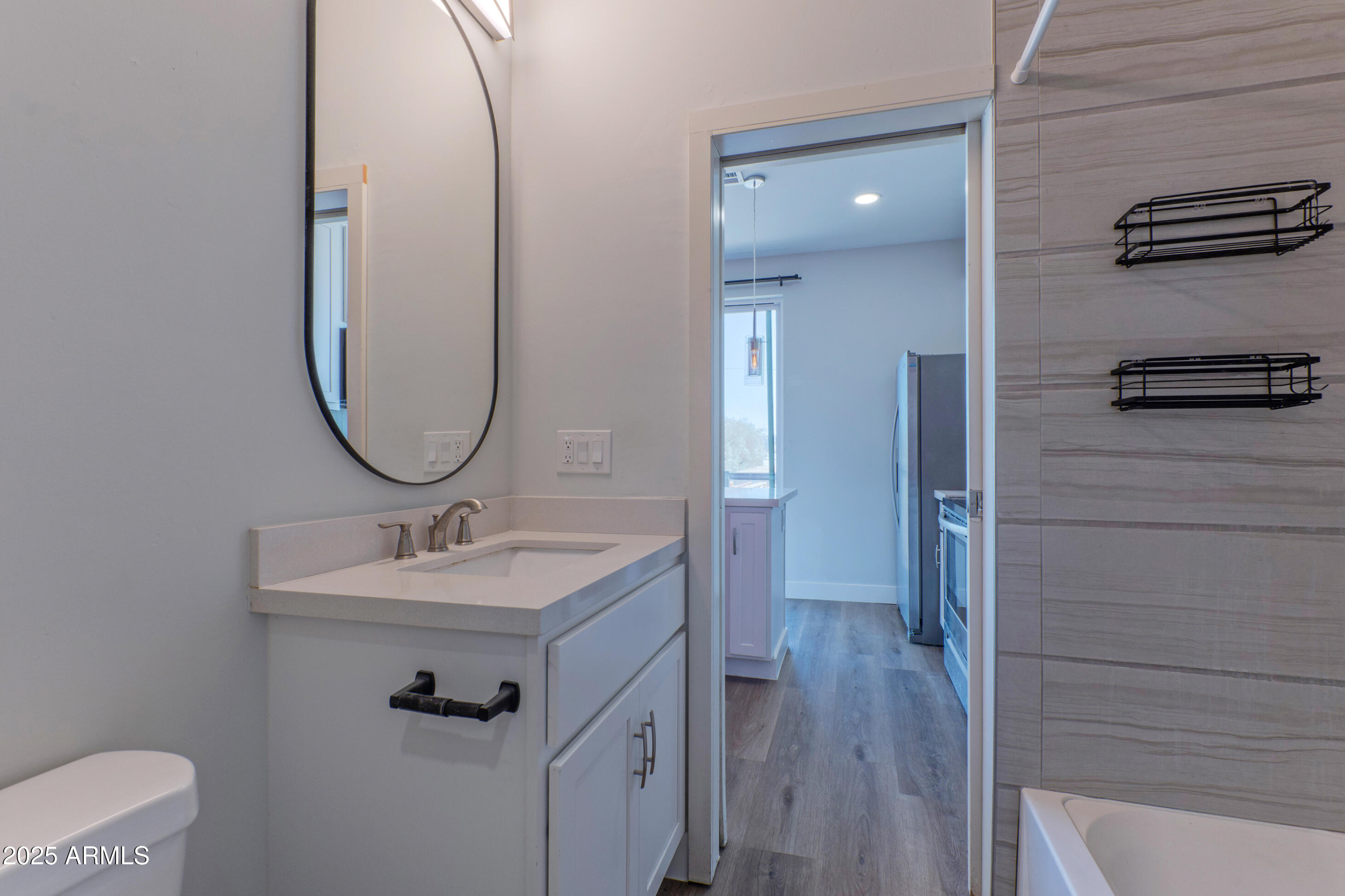 1106 South Montezuma Avenue Phoenix, AZ 85003 - Photo 9 of 15 a bathroom with a sink a mirror and vanity