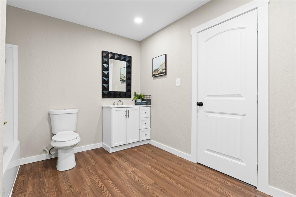 175 Hcr-4434 Itasca, TX 76055 - Photo 12 of 30 a bathroom with a toilet sink and mirror