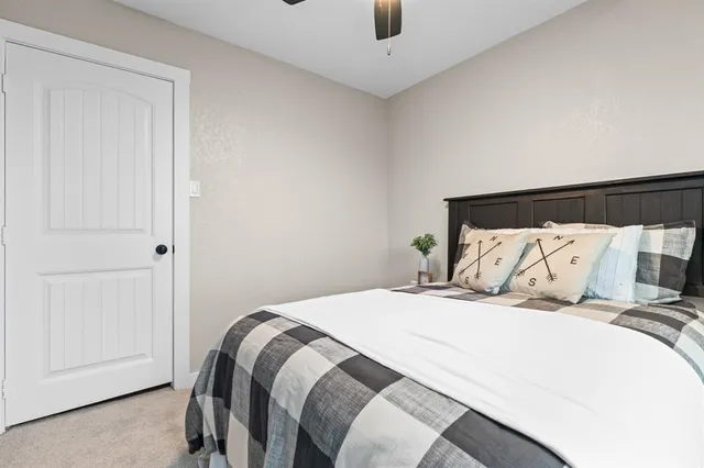 a bedroom with a bed and a mirror