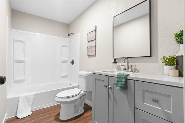 a bathroom with a sink toilet a tub and shower