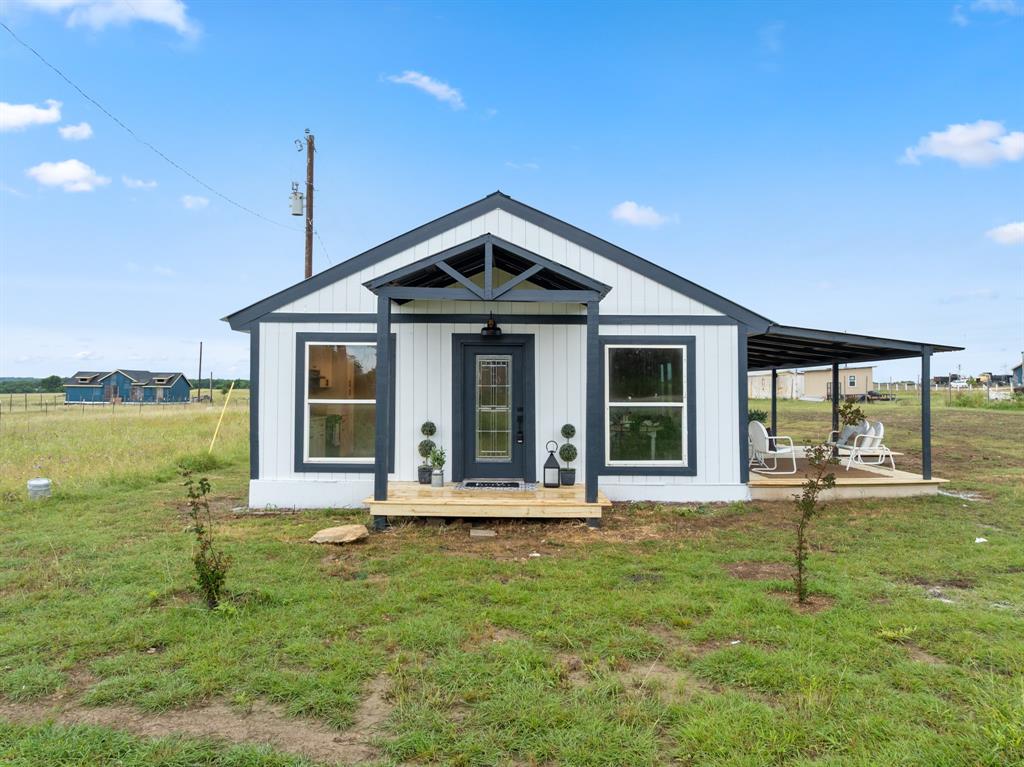 175 Hcr-4434 Itasca, TX 76055 - Photo 22 of 30 a front view of a house with a yard table and chairs