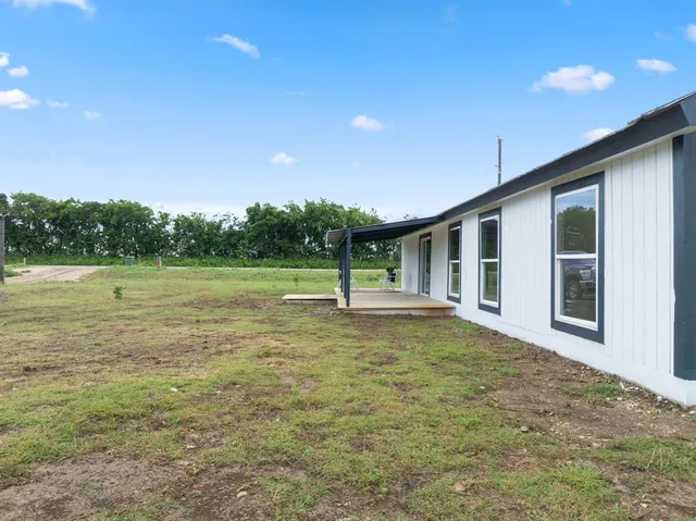 a swimming pool with some trees in the background