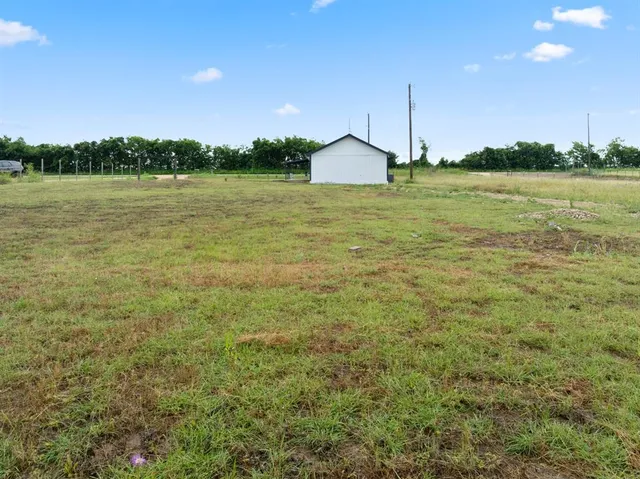 a view of a patio with a yard