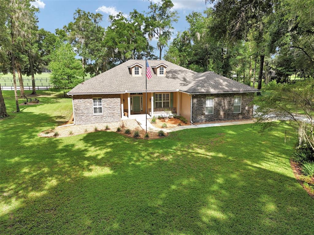 1989 Northwest 111th Loop Ocala, FL 34475 - Photo 4 of 55 a front view of a house with garden