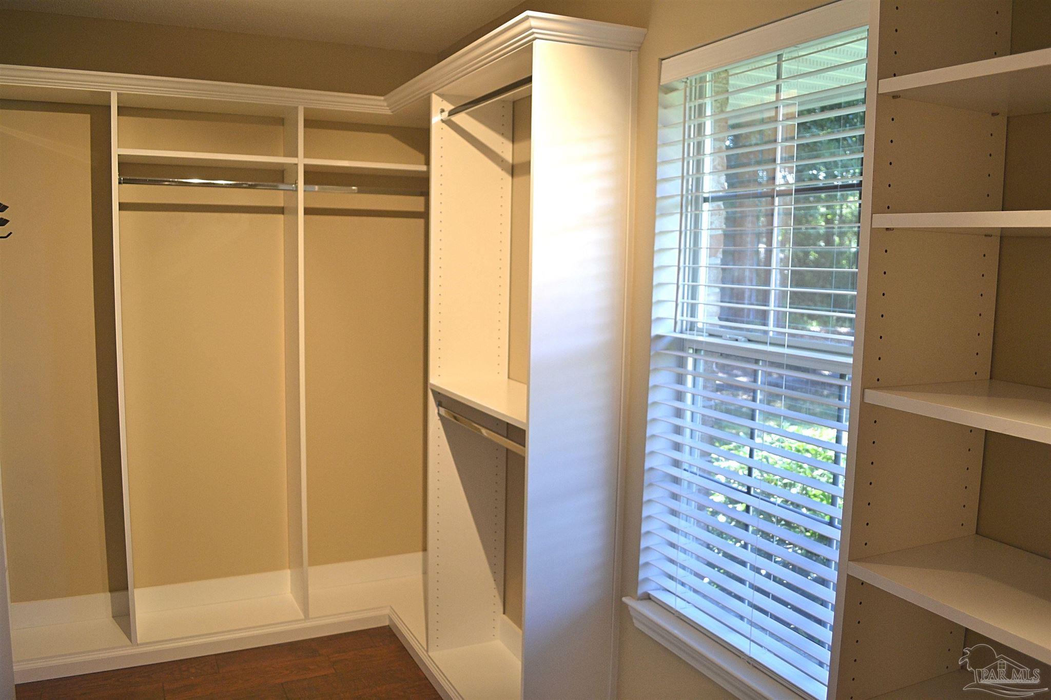 3055 Wallace Lake Road Pace, FL 32571 - Photo 27 of 33 a view of walk in closet with wooden floor