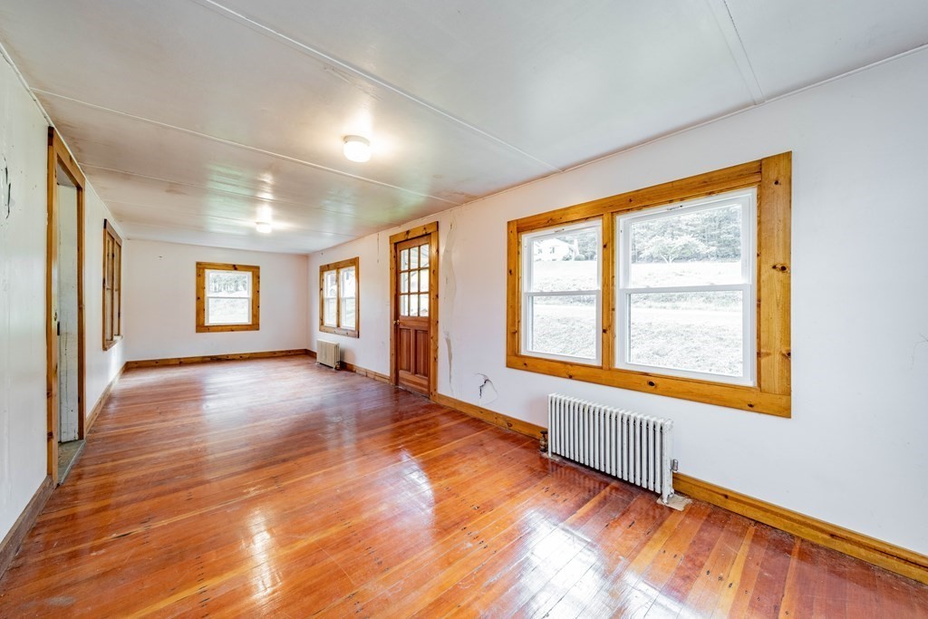82 Lyman Road Chester, MA 01011 - Photo 13 of 40 a view of an empty room with a window and wooden floor