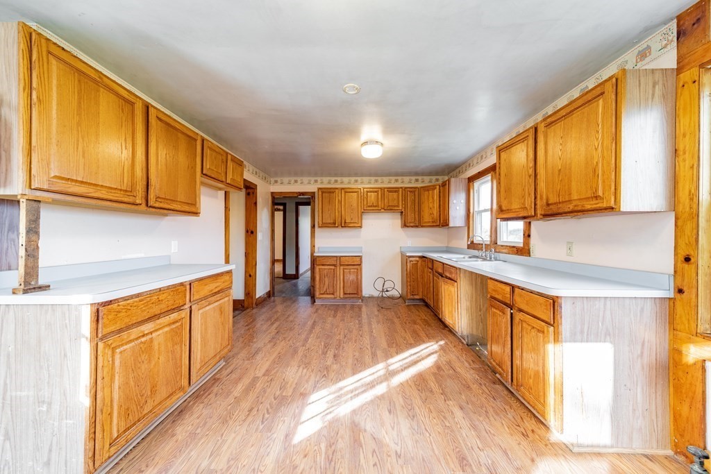 82 Lyman Road Chester, MA 01011 - Photo 4 of 40 a large kitchen with stainless steel appliances granite countertop a large stove a sink dishwasher and cabinets with wooden floor