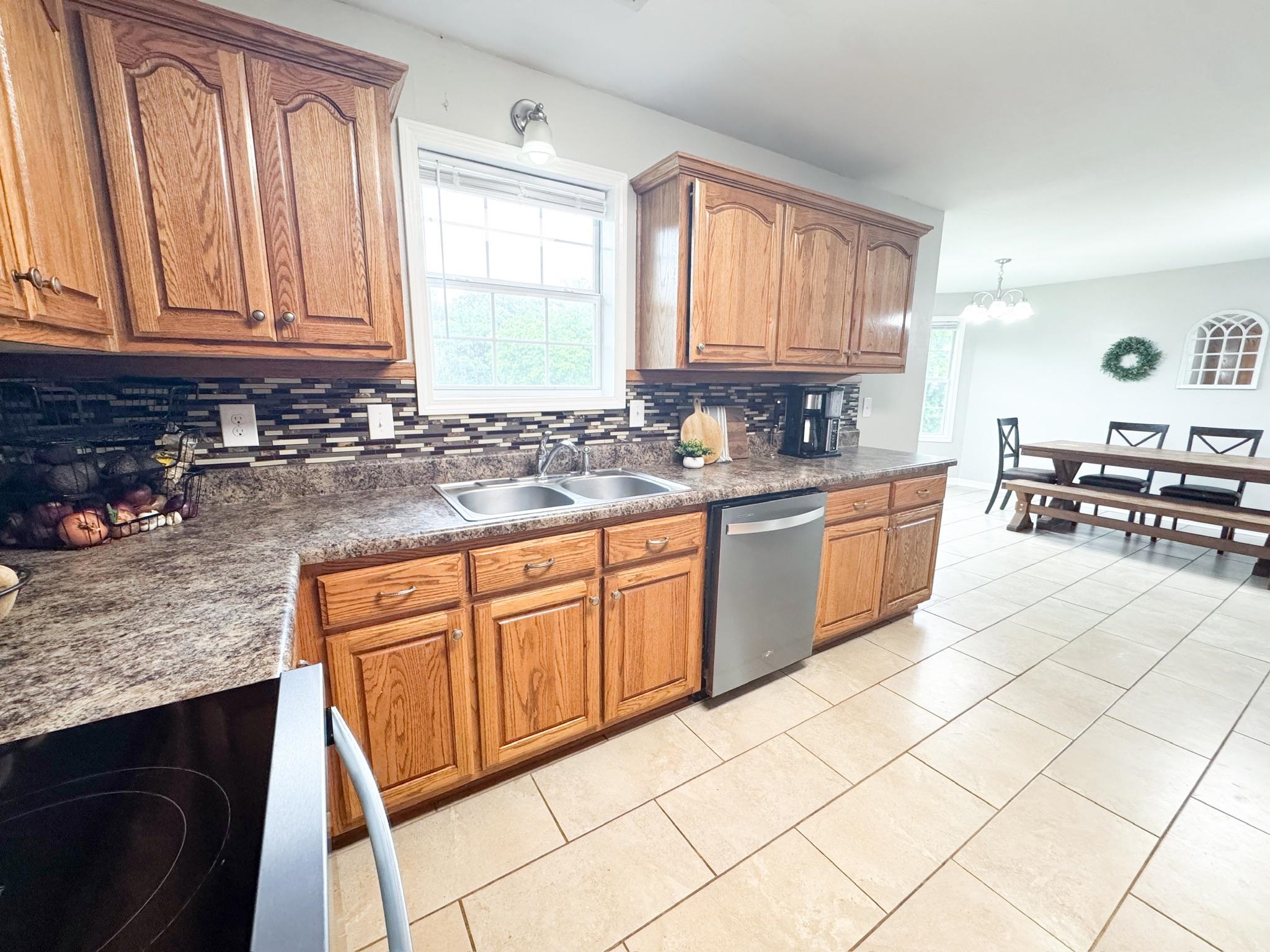4776 Campground Road Munford, TN 38058 - Photo 7 of 25 a kitchen with stainless steel appliances granite countertop a sink stove and cabinets